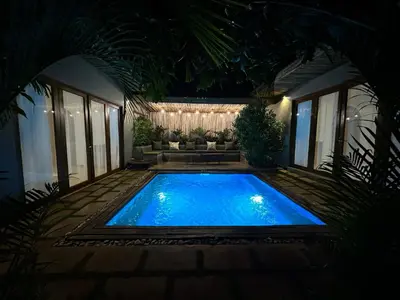 a swimming pool in the middle of a yard at night at Tulivu Kilimanjaro Retreat in Moshi