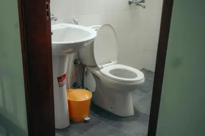 a bathroom with a toilet and a sink at Mesa Home Apartment in Arusha