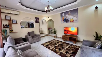 a living room with two couches and a television at Ultra Home - Bed and Breakfast in Themi