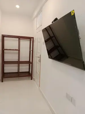 a flat screen tv hanging on a wall in a room at Hidalgo Home Apartment's in Moshi