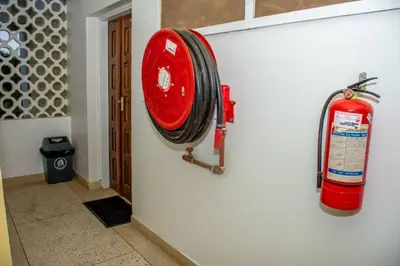 a fire hydrant hanging on the side of a wall at aaaa in Arusha
