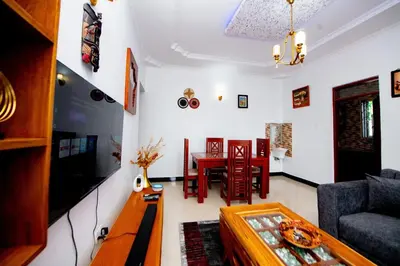 a living room with a couch and a table at Private Nest Apartment 2 in Nkoanrua
