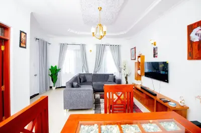 a living room with a couch and a table at Private Nest Apartment 2 in Nkoanrua