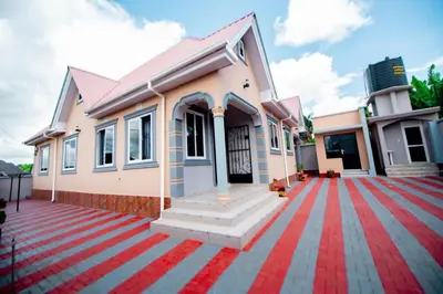 a house with a red carpet in front of it at Private Nest Apartment 2 in Nkoanrua