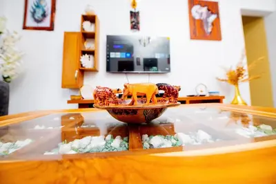 a glass table with a toy on a bowl on top of it at Private Nest Apartment 2 in Nkoanrua
