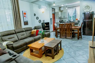a living room with a couch and a table at Bellevie Homestay in Uru