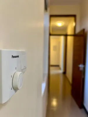 a room with a door and a wall with a lightswitch at Tai Africa Rooms in Arusha