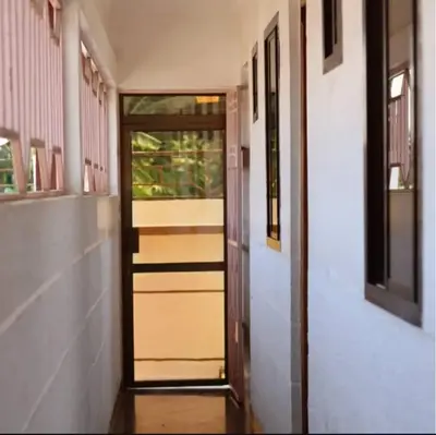 a hallway with a door leading into a room at Otakef Motel in Arusha