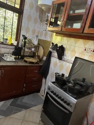 a kitchen with a stove with pots and pans on it at Wimake homes in Arusha