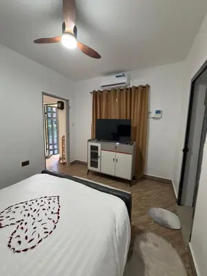 a bedroom with a bed and a flat screen tv at Afrika Royal Safari in Arusha