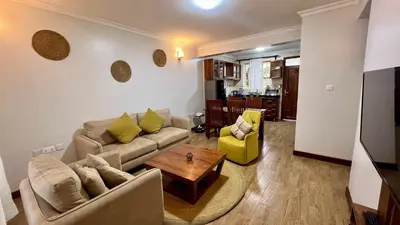 a living room with a couch and a table at Iwandaa Lodge in Nkoanrua