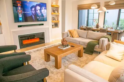 a living room with a fireplace and a tv at Modern Farmhouse & French Elegance Stay for 6 in Arusha