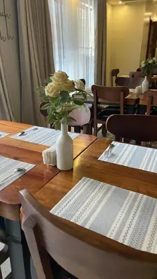 a table with a vase of flowers on top of it at Boma masai Garden in Boma la Ngombe